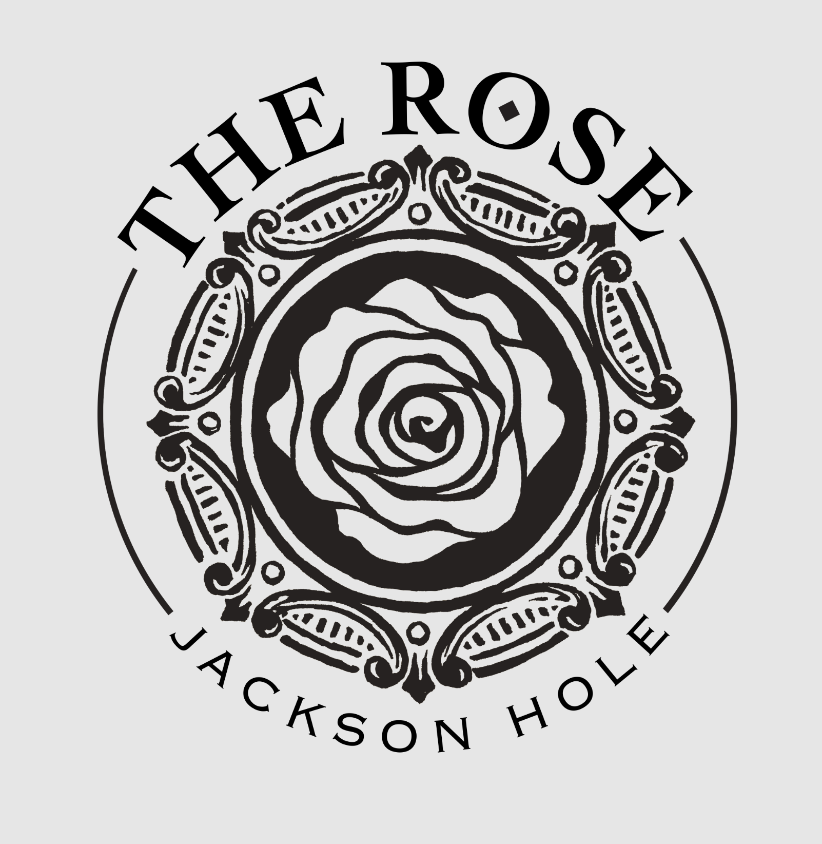 Original Circular logo with central stylized rose illustration surrounded by ornate decorative elements and arched text 'THE ROSE' above and 'JACKSON HOLE' below. logo featuring black, light gray colours