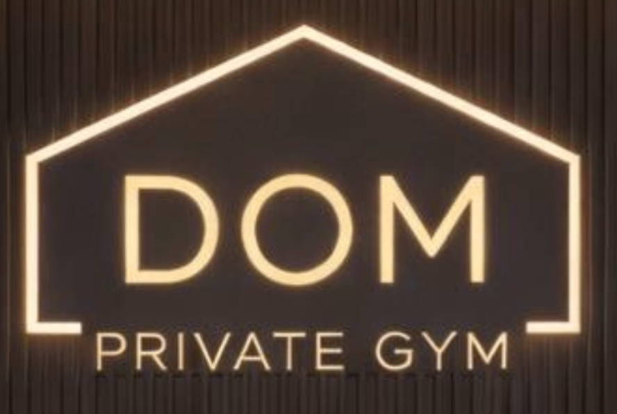 Original warm white text 'DOM PRIVATE GYM' centered within a warm white house-shaped line graphic on a dark background logo featuring black, warm white, dark brown colours