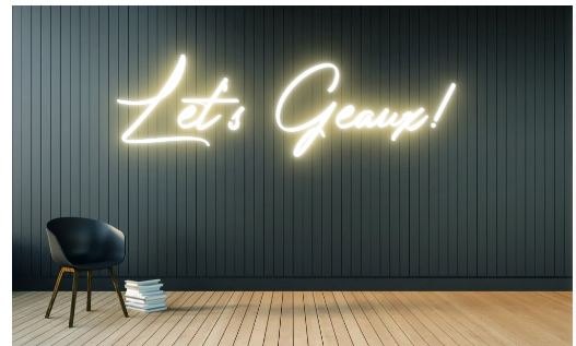 Original warm white script text 'Let's Geaux!' styled as a continuous neon tube sign logo featuring black, light wood, warm white colours